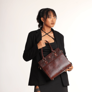 A girl in formal dress carrying a Miva Wine Maroon bag.