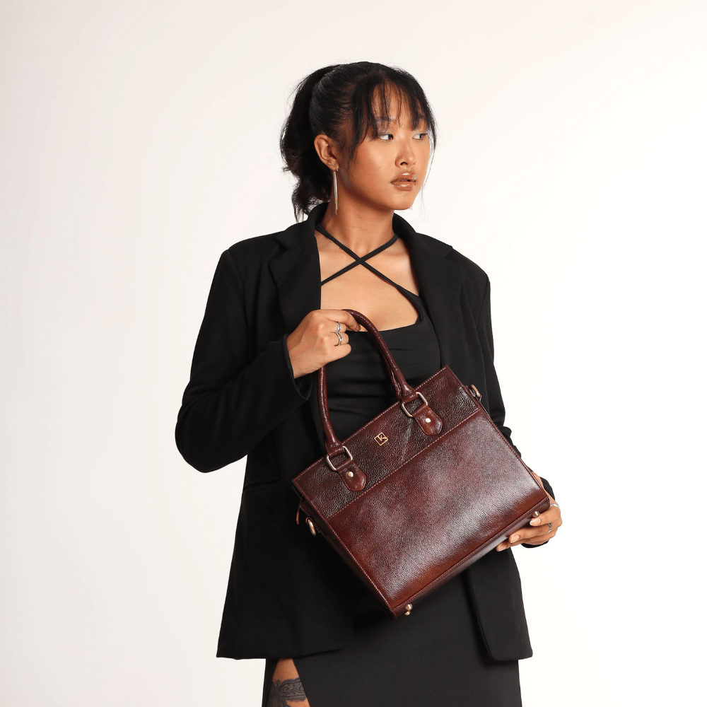 A girl in formal dress carrying a Miva Wine Maroon bag.