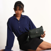 A girl sitting and posing with Elira Green leather bag