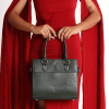 A girl in red dress standing and carrying a MIVA Forest Green color bag.