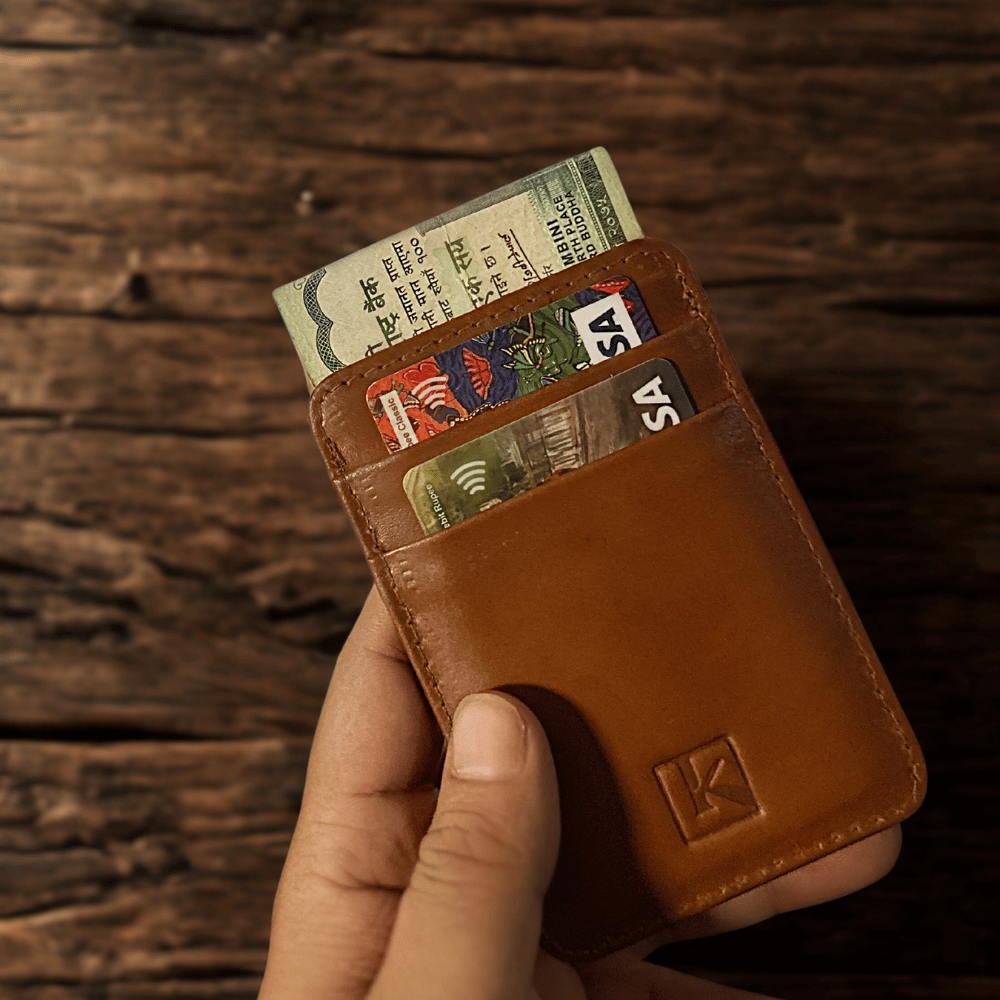A front view of a tan color cardholder with some cards and money.