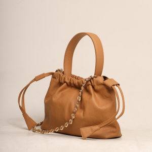 Artisanal Camel Tan leather Thaili bag with a structured drawstring design and gold accents, designed by The Karigar Nepal.
