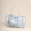 A handcrafted Sky Blue premium leather Thaili bag by The Karigar Nepal featuring a gold-tone chain strap and gathered drawstring opening.