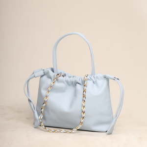 A handcrafted Sky Blue premium leather Thaili bag by The Karigar Nepal featuring a gold-tone chain strap and gathered drawstring opening.