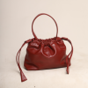 Ruby Red genuine leather Thaili bag with a gathered silhouette and artisanal top handle, handcrafted by The Karigar Nepal.
