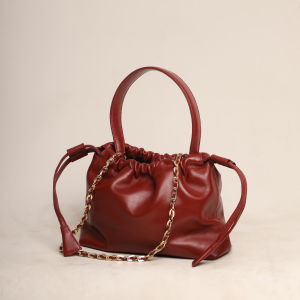 Ruby Red genuine leather Thaili bag with a gathered silhouette and artisanal top handle, handcrafted by The Karigar Nepal.