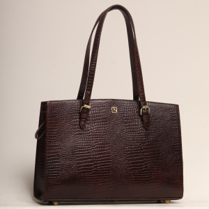 Front view of the Maya Tote Laptop Bag by The Karigar Nepal in deep brown croc-embossed leather, featuring gold-tone hardware, adjustable buckled shoulder straps, and the signature k logo.